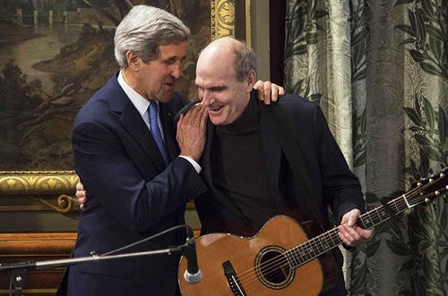 PARIS, FRANCE - JANUARY 16 :  U.S. Secretary of State John Kerry (L) listens US musician James Taylor (R) after a  press conference at Paris City Hall on January 16, 2015. (Photo by Geoffroy Van der Hasselt/Anadolu Agency/Getty Images)