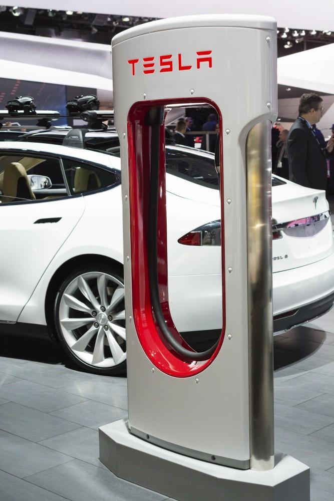 Detroit, MI, USA - January 12, 2015: Tesla Model S and charging station on display during the 2015 Detroit International Auto Show at the COBO Center in downtown Detroit.