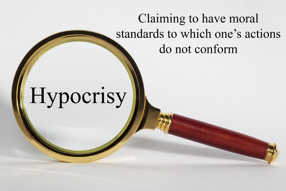 Hypocrisy Concept - looking at hypocrisy through a magnifying glass, and definition.