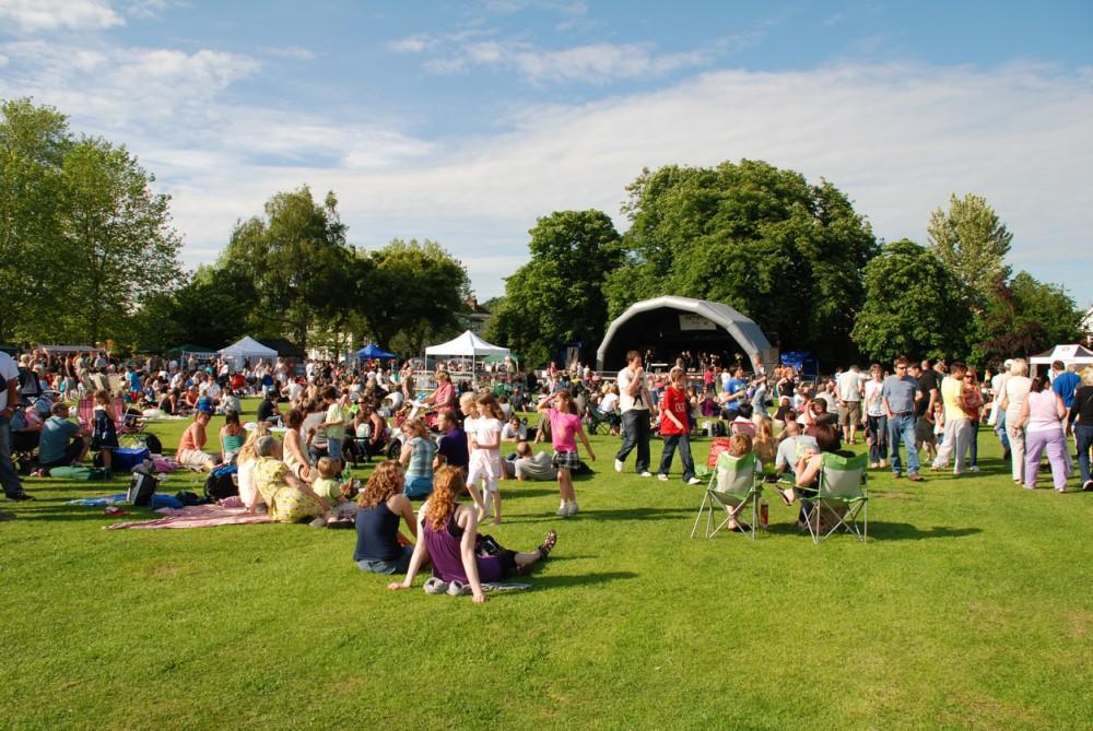 Tenterden, England - June 13, 2009: The audience watching the free local music festival at Tenterden in Kent. The annual event held in the local public park showcases local talent.