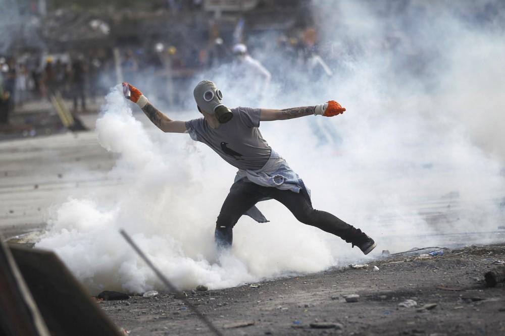 Istanbul, Turkey - June 11, 2013: Hundreds of protesters clashed with police in Taksim Square. A wave of demonstrations and civil unrest in Turkey began on 28 May 2013, initially to contest the urban development plan for Istanbuls Taksim Gezi Park. The protests were sparked by outrage at the violent eviction of a sit-in at the park protesting the plan.