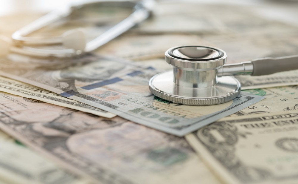 medical cost, stethoscope on dollar banknote money. concept of health care costs, finance, health insurance fund.