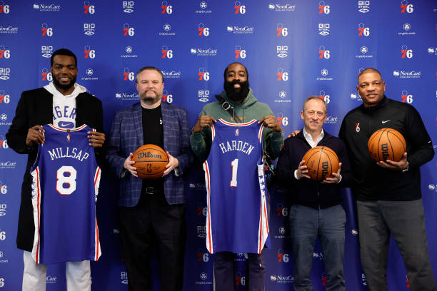 CAMDEN, NEW JERSEY - FEBRUARY 15: (L-R) Paul Millsap #8, president of basketball operations Daryl Morey, James Harden #1, team owner and managing partner Josh Harris, and head coach Doc Rivers of the Philadelphia 76ers pose for photos during a press conference at the Seventy Sixers Practice Facility on February 15, 2022 in Camden, New Jersey. (Photo by Tim Nwachukwu/Getty Images) NOTE TO USER: User expressly acknowledges and agrees that, by downloading and or using this photograph, User is consenting to the terms and conditions of the Getty Images License Agreement.